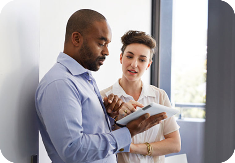 Man talking to a woman about report